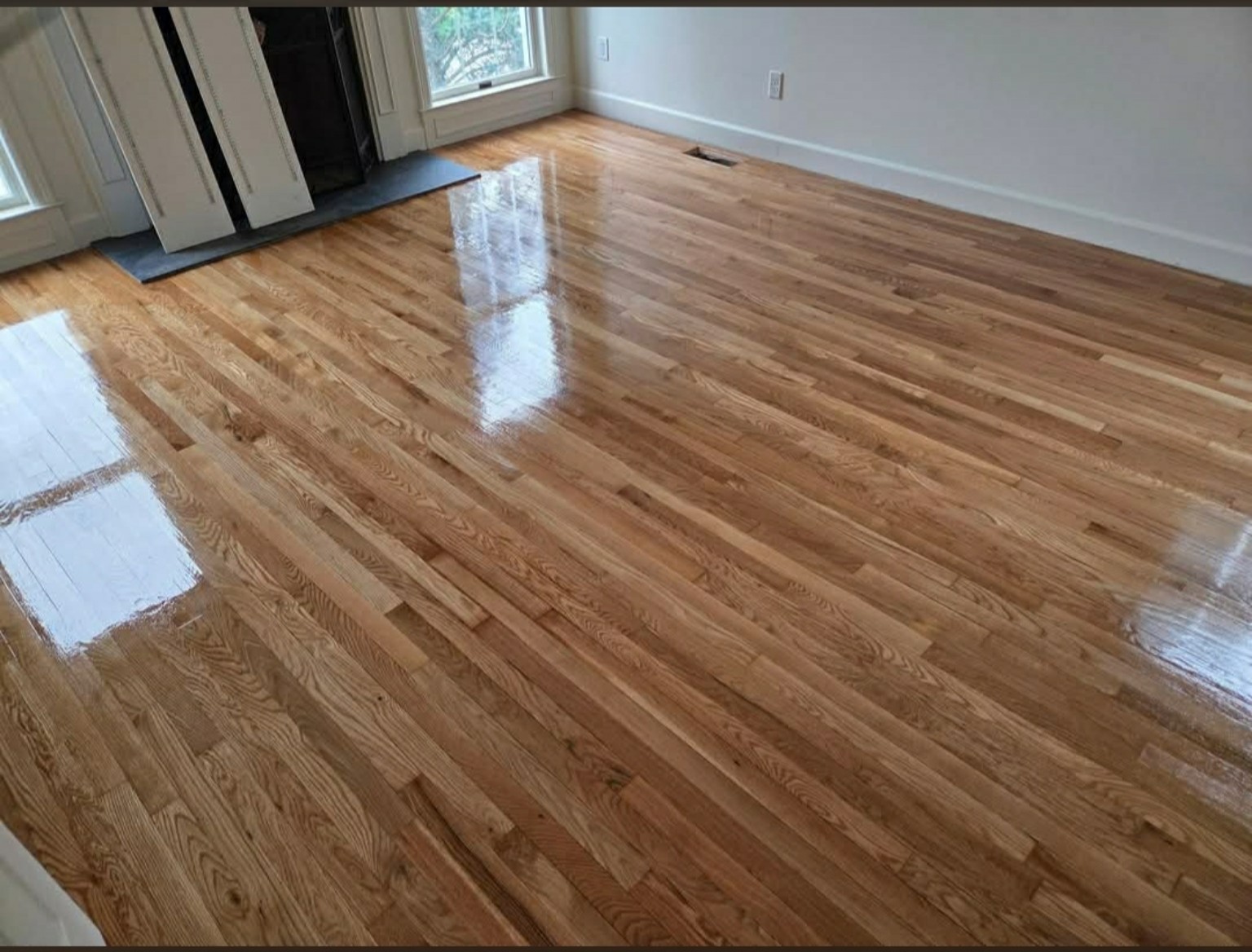 Hardwood flooring beside a fireplace, a D&D Hardwood Floors project